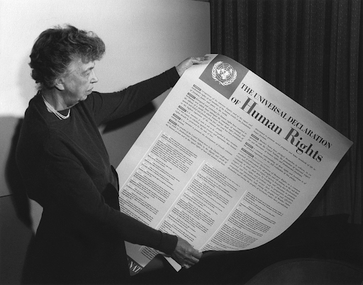 Eleanor Roosevelt holding up paper on The Universal Declaration of Human Rights